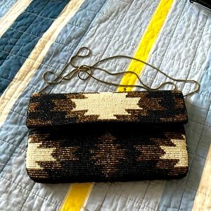 Women’s clutch hand bag with chain that could be worn as a shoulder or crossbody
